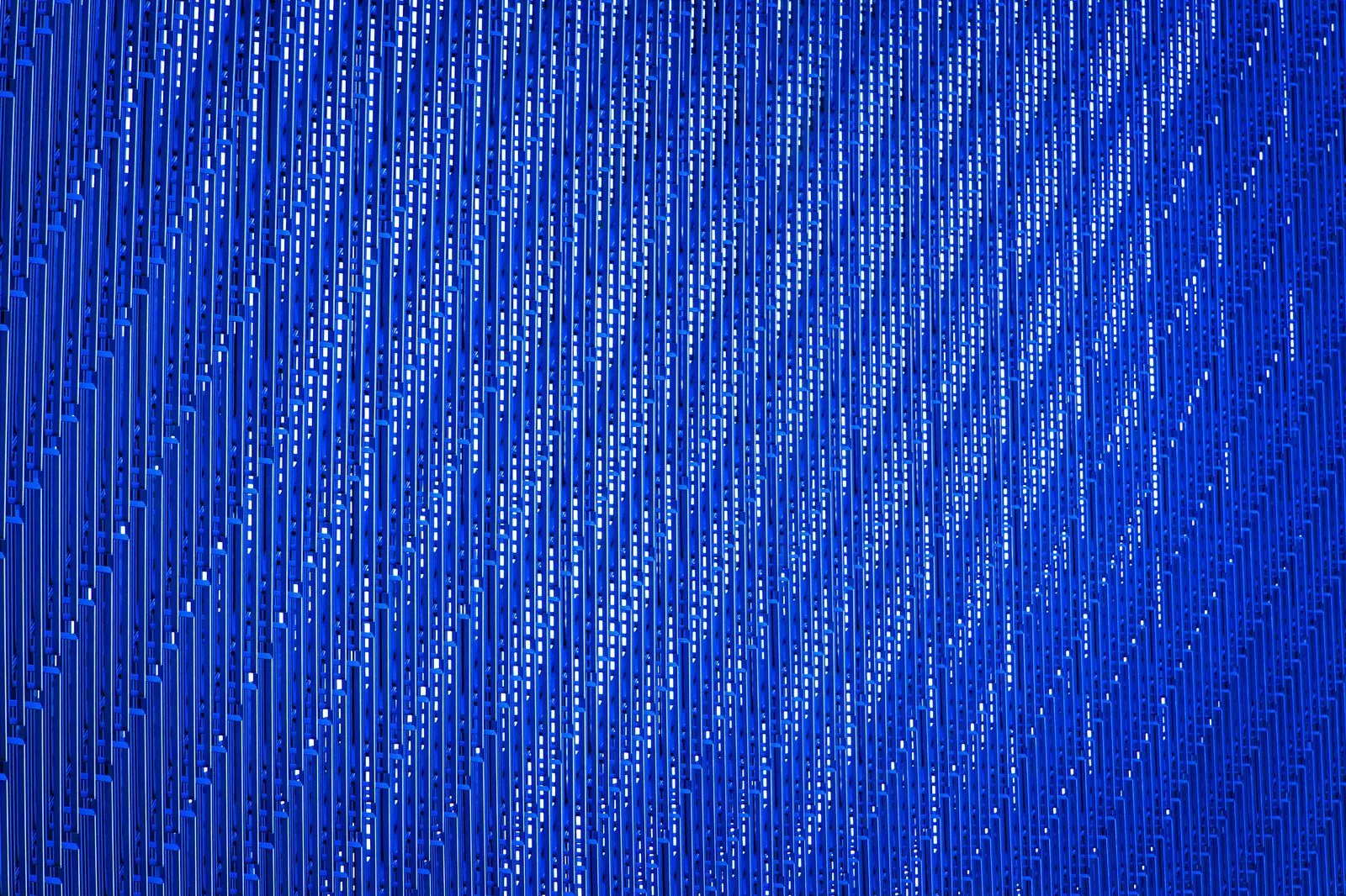 Close-up of illuminated blue perforated panels